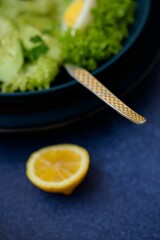 Closeup of a lime next to the salad