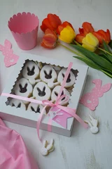 Foto auf Leinwand Beautiful view of easter theme cookies with bunny shape next to the colorful tulips © Nenad Zivanovic/Wirestock Creators