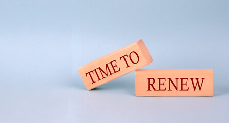 TIME TO RENEW text on the wooden block, blue background