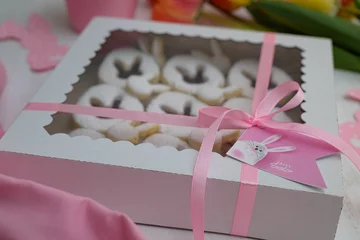 Fotobehang Closeup view of Easter themed cookies in the box © Nenad Zivanovic/Wirestock Creators