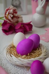 Closeup view of eggs colored in pink  on an artificial nest