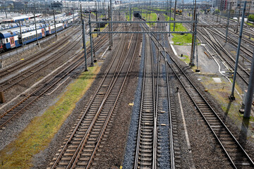 Several empty parallel train tracks in major rail hub in European city. Above view, trains, no...
