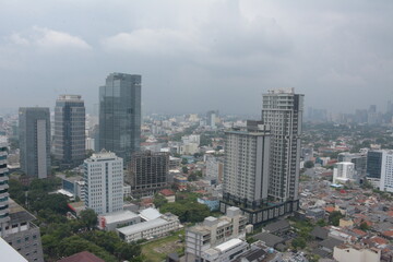Fototapeta na wymiar Jakarta, Indonesia - March 3, 2023 - View from the top of the National Library of Indonesia building. Aerial view of Jakarta city, many houses and tall buildings