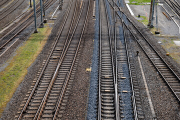 Several empty parallel train tracks in major rail hub in European city. Above view, trains, no...