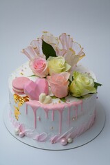 Vertical shot of a cake decorated with macaroons and flowers