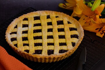 Closeup of an Italian crostata near orange flowers