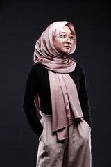 Cute young Asian hijab corporate girl with smooth glowing skin smiling and relaxing over an isolated background studio. Beauty skin care, office concept.