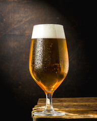 glass of beer on dark background