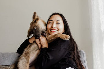 Photograph of woman playing with her little adopted dog. Concept of love for animals.