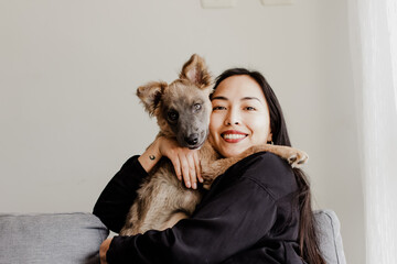 Photograph of woman playing with her little adopted dog. Concept of love for animals.