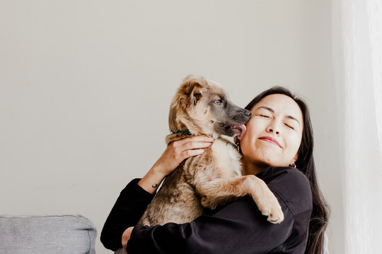 Photograph of woman playing with her little adopted dog. Concept of love for animals.