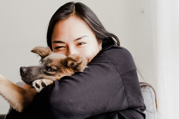 Photograph of woman playing with her little adopted dog. Concept of love for animals.