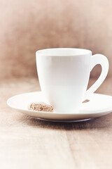 Amaretti (Italian biscuit) and a cup of coffee on wooden background. Close up. Copy space. 