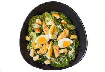Caesar salad served in Vietnamese style on black background