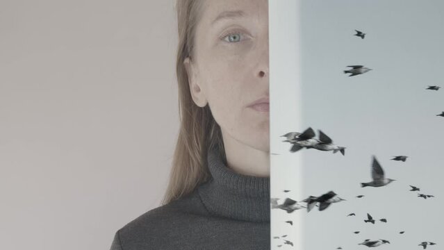 Portrait of a young woman whose face is half hidden behind a wall on which a flock of birds flies on a white background. Cg
