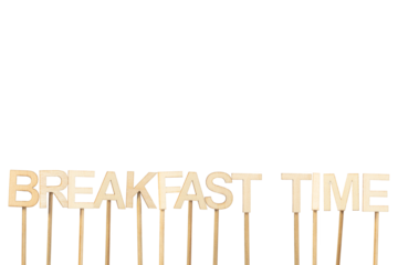 Breakfast time sign made with individual wooden letters on a green chroma background.