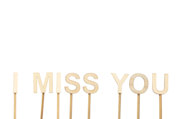 I miss you sign made with individual wooden letters on a green chroma background.