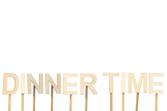 Dinner time sign made with individual wooden letters on a green chroma background.