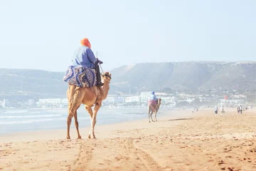 Foto op Plexiglas Beduin riding a camel on the main beach of Agadir, Morocco © Jan