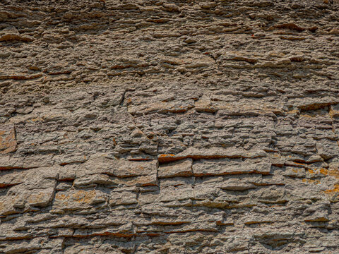 Cliffed River Shore, Klip. Layers Of Limestone Of The Ordovician Period. Good Building Stone, Geological Record And A Collection Of Extinct Organisms. Limestone Background