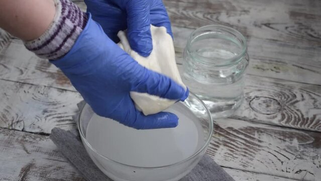Making mozzarella cheese. Melting and stretching spun paste from hot water. Preparing pasta filata types of cheese