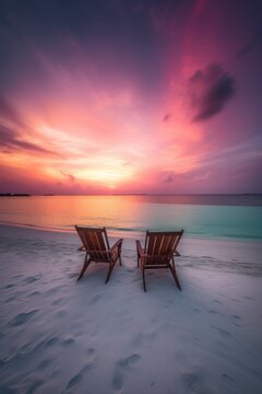 Two beach chairs on the beach of the Maldives at a beautiful sunset. Generative AI © piai