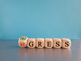 Regress or progress symbol. Turned wooden cubes and changes the word Regress to Progress. Beautiful...