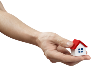 Hand holding a small red roofed house, cut out