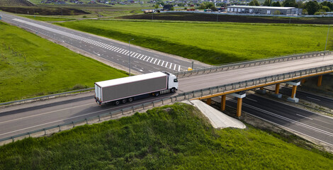Truck with Cargo Semi Trailer Moving on Road in Direction. Highway intersection junction. Aerial Top View - 592727177
