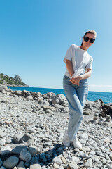 a woman by the sea stone beach walking journey