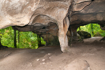 Huel Lee or Hohllay on the Mullerthal trail in Luxembourg, open cave with view to the forest, sandstone rock formation
