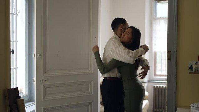 Boyfriend hugging frustrated argumentative girlfriend. Man reconciling with young woman embracing her so she can calm down