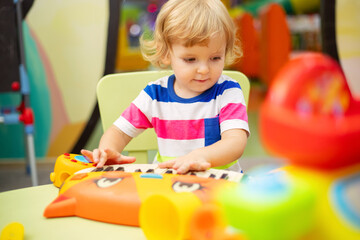 Child playing with colorful toys at the learning center or in kindergarten