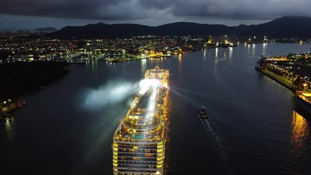 Transatlantic cruise ship at night, starting a tourist trip departing from the port of Santos.
