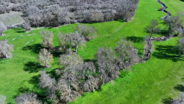 Meanders in the Lucio River in Renedo de la Inera. Aerial view from a drone. Recuevas Valley. World geological heritage UNESCO. Las Loras Geopark. Palencia. Castile and Leon. Spain, Europe