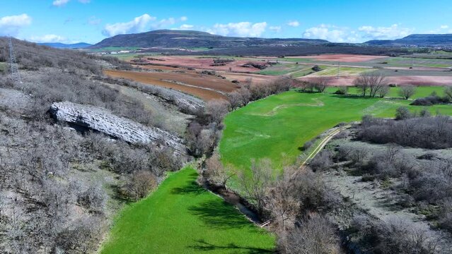 Meanders in the Lucio River in Renedo de la Inera. Aerial view from a drone. Recuevas Valley. World geological heritage UNESCO. Las Loras Geopark. Palencia. Castile and Leon. Spain, Europe