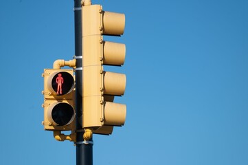 Red light for the pedestrian on the blue background of the sky