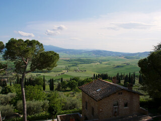Picturesque tuscan landscape near Pienza, Italy with old town house