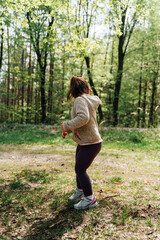 A child girl in the forest by hiking trail. Happy outdoorsy childhood. Getting fresh air