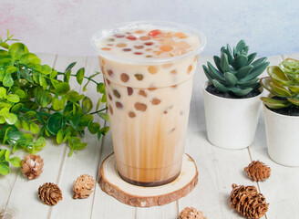 Brown Sugar Creamy Milk with bubbles served om disposable glass isolated on wooden board top view of hong kong drink