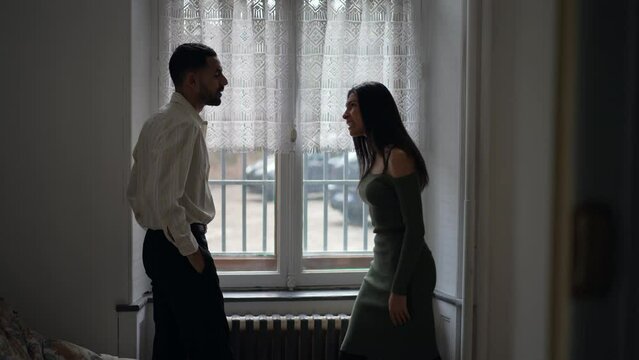 Candid couple fighting, man pointing finger blaming for problems, pushing her away and girlfriend hitting back on boyfriend face. Woman slapping guy. Relationship in crisis