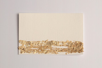 Gold (bronze) glitter empty canvas frame on beige gray paper background. Abstract copy space texture.