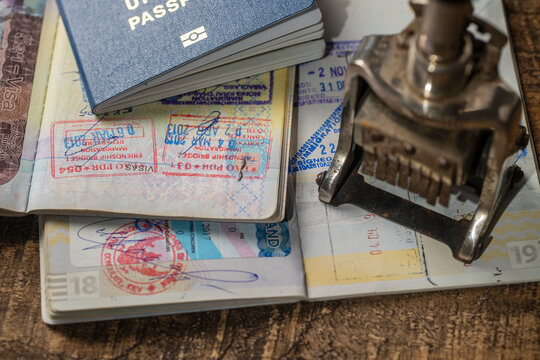 Immigration and passport control at the airport. Border control a stamp in the international passport, closeup. Vacation and travel concept