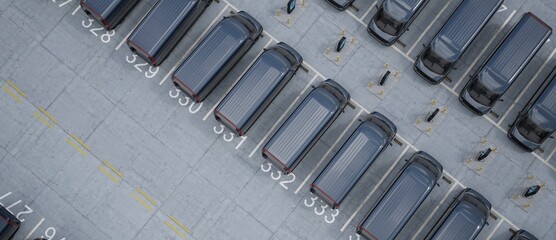 Overhead high angle drone shot of fleet modern electric EV delivery vans standing in company parking garage near charging stations