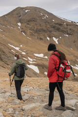 Two friends hiking in the mountains at winter