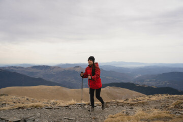 Fototapeta premium Girl hiking in the mountains at winter