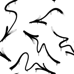 Obraz premium Seamless pattern of sprayed graffiti arrows with overspray in black over white. Vector illustration template