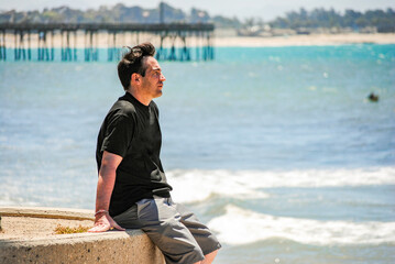 A man looking the ocean near Ventura Pier