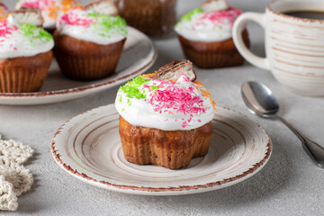 Homemade cupcakes with protein cream sprinkled with colorful coconut flakes