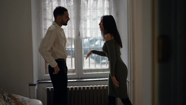 Domestic abuse: Male partner pushing woman away with hand. Girlfriend slaps boyfriend during violent altercation. Relationship in crisis